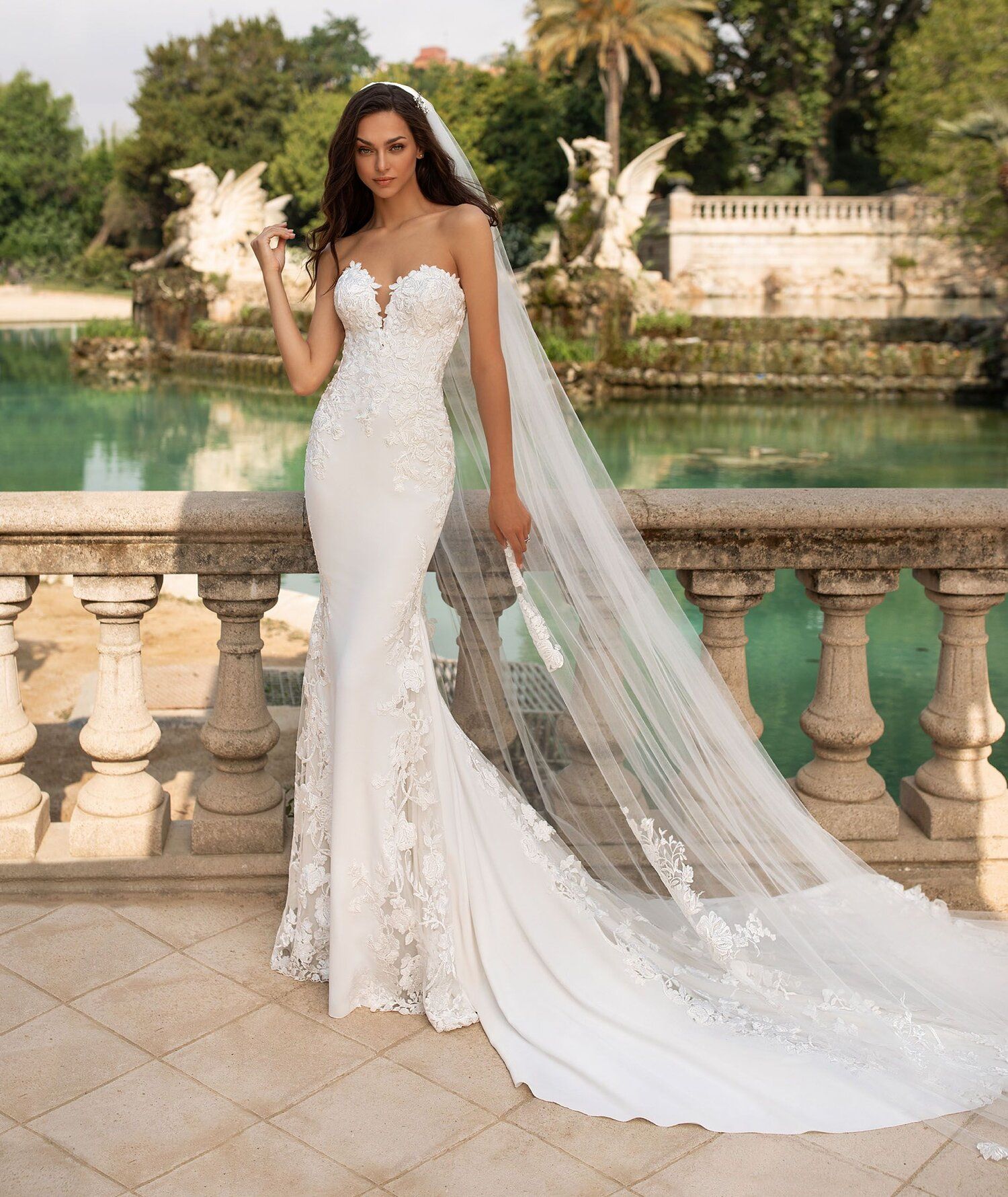 A woman in a wedding dress is laying on a set of stairs.