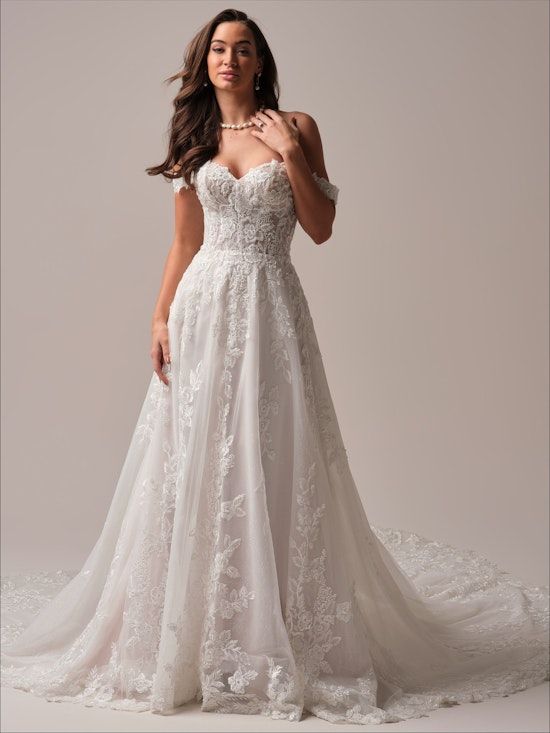 A woman in a white wedding dress is standing on a white background.