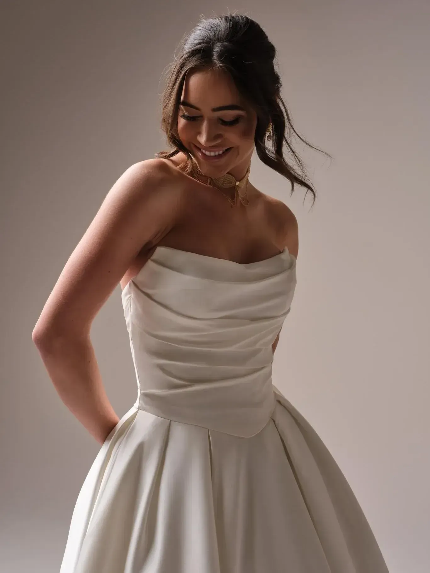 A woman in a wedding dress is standing on a beach.