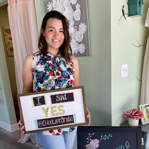 A woman is holding a sign that says `` i said yes ''.
