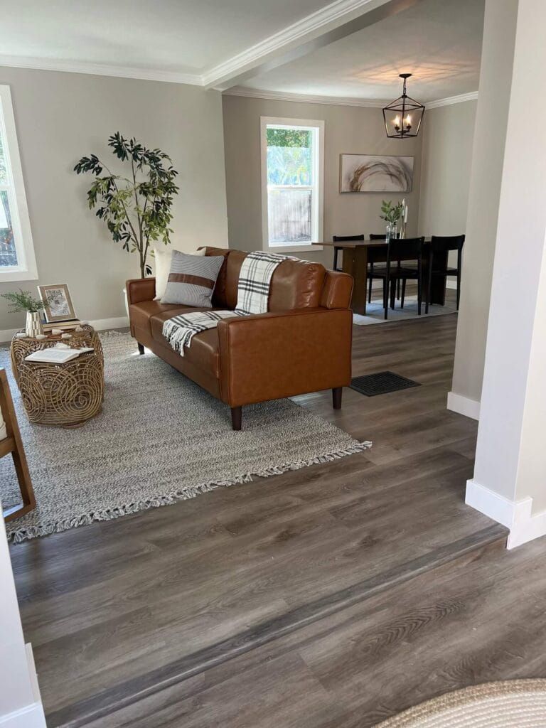 A Living Room With a Brown Leather Couch and a Rug