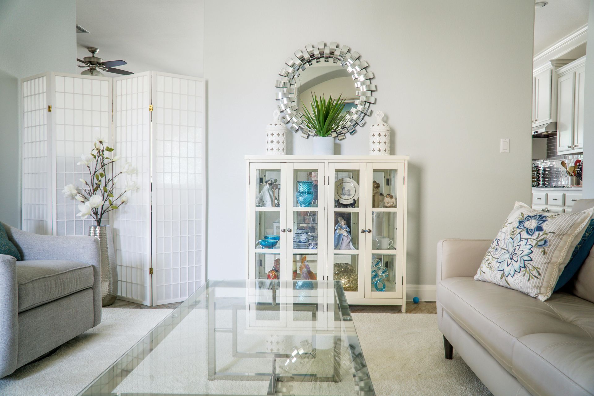 A Living Room With a Couch and a Glass Coffee Table