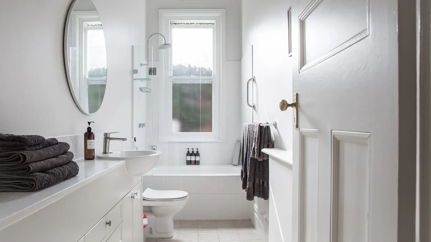 A small bathroom with cabinet storage