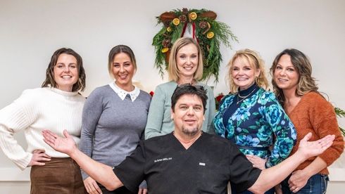 The logo for dr. gillis 's wellness center says `` we care ''.