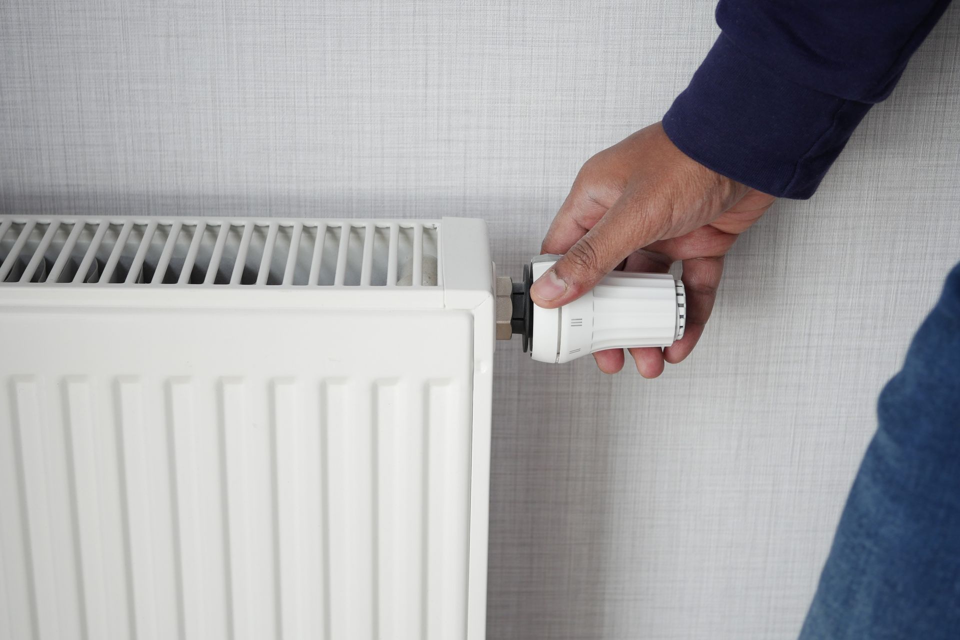 HVAC technician performing a heater tune-up to prepare for the winter season.