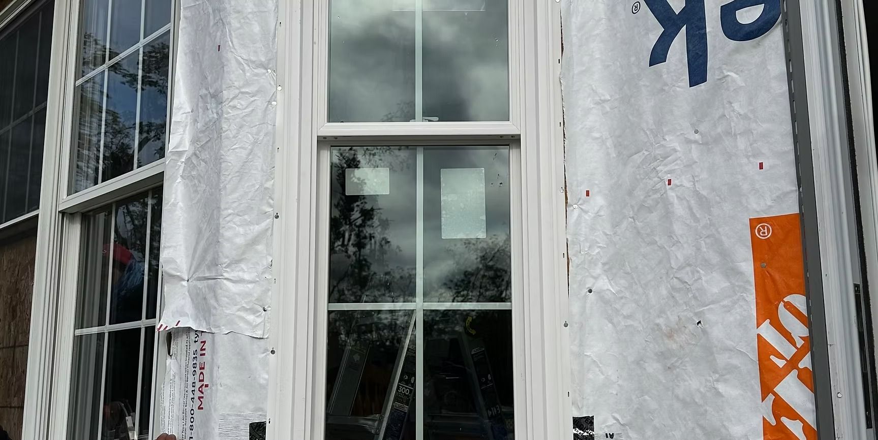 A window is being installed on the side of a building.