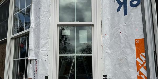 A window is being installed on the side of a building.