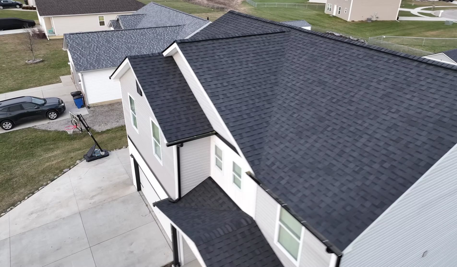 An aerial view of a house with a black roof.
