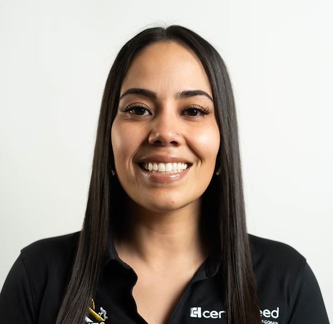 A woman wearing a black shirt that says acer is smiling