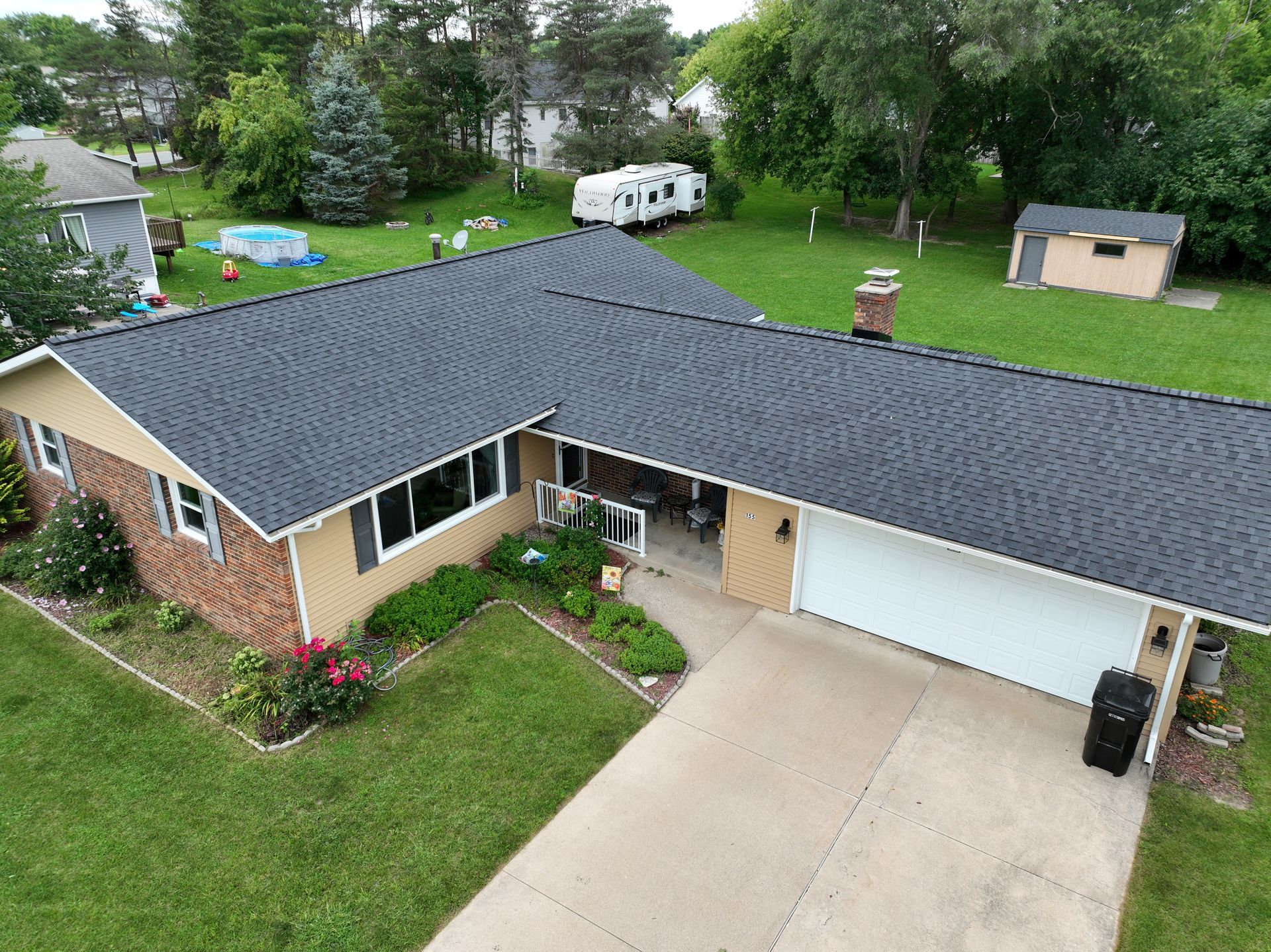 An aerial view of a house with a black roof.