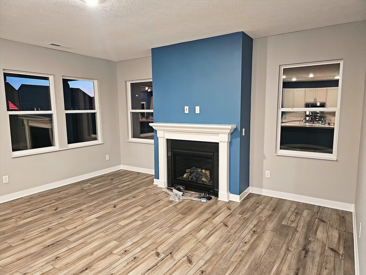 There is a fireplace in the middle of the living room.