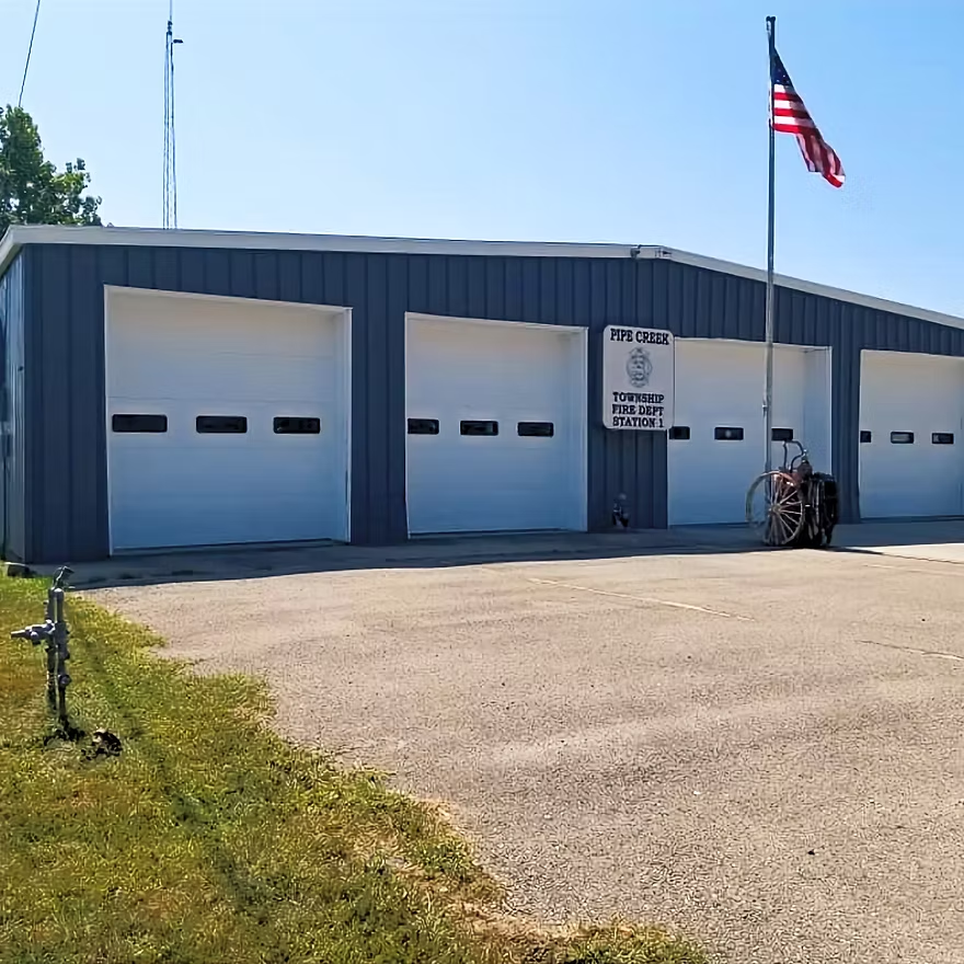 A motorcycle is parked in front of a fire station