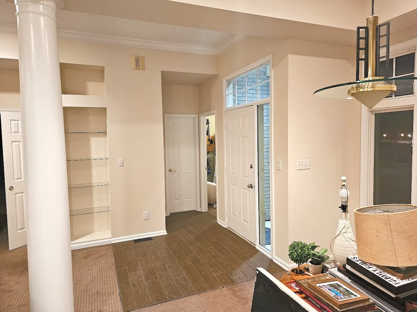 A living room with a ceiling fan and a lamp