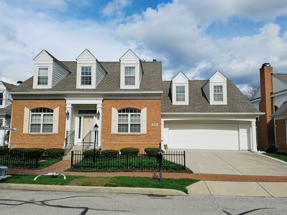 A large brick house with a white garage door