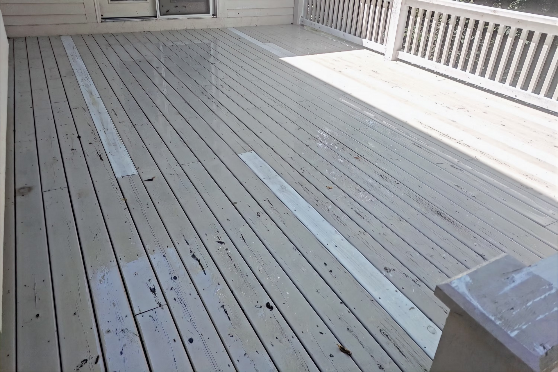 A white wooden deck with a white railing