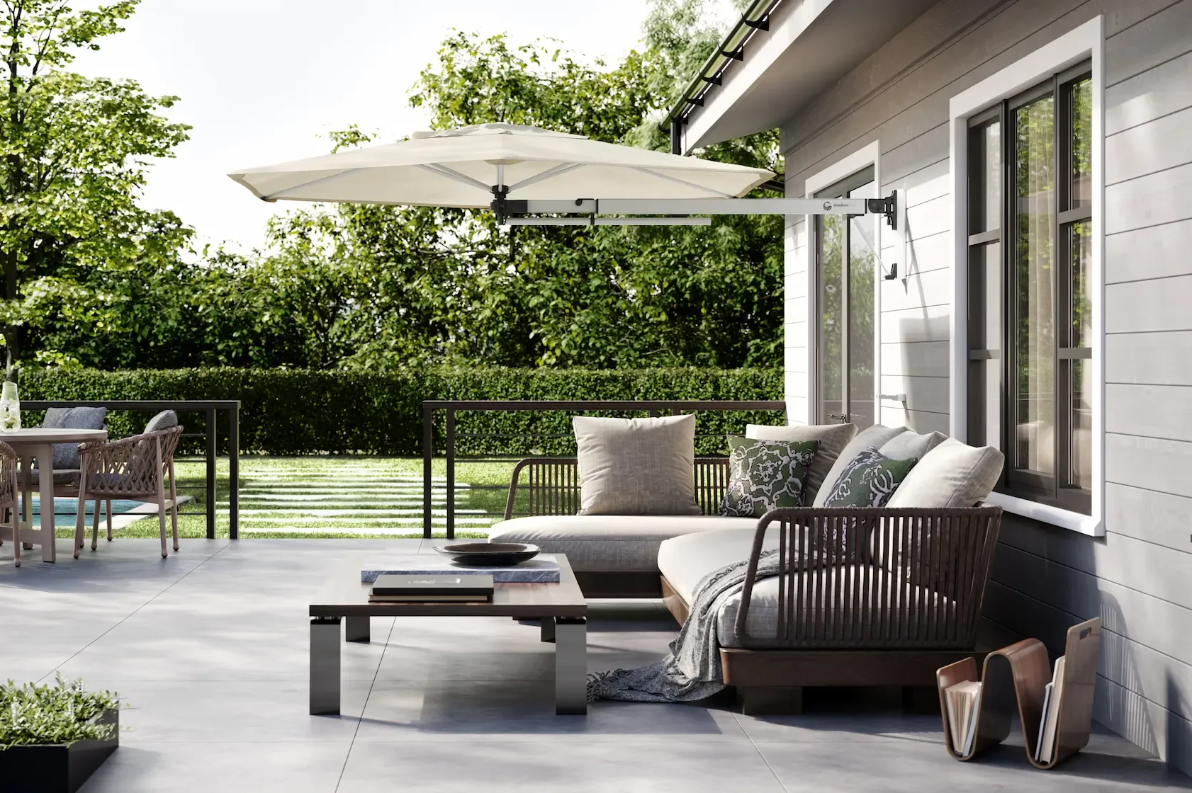 Contemporary home with a retractable awning, overlooking a scenic waterfront view.