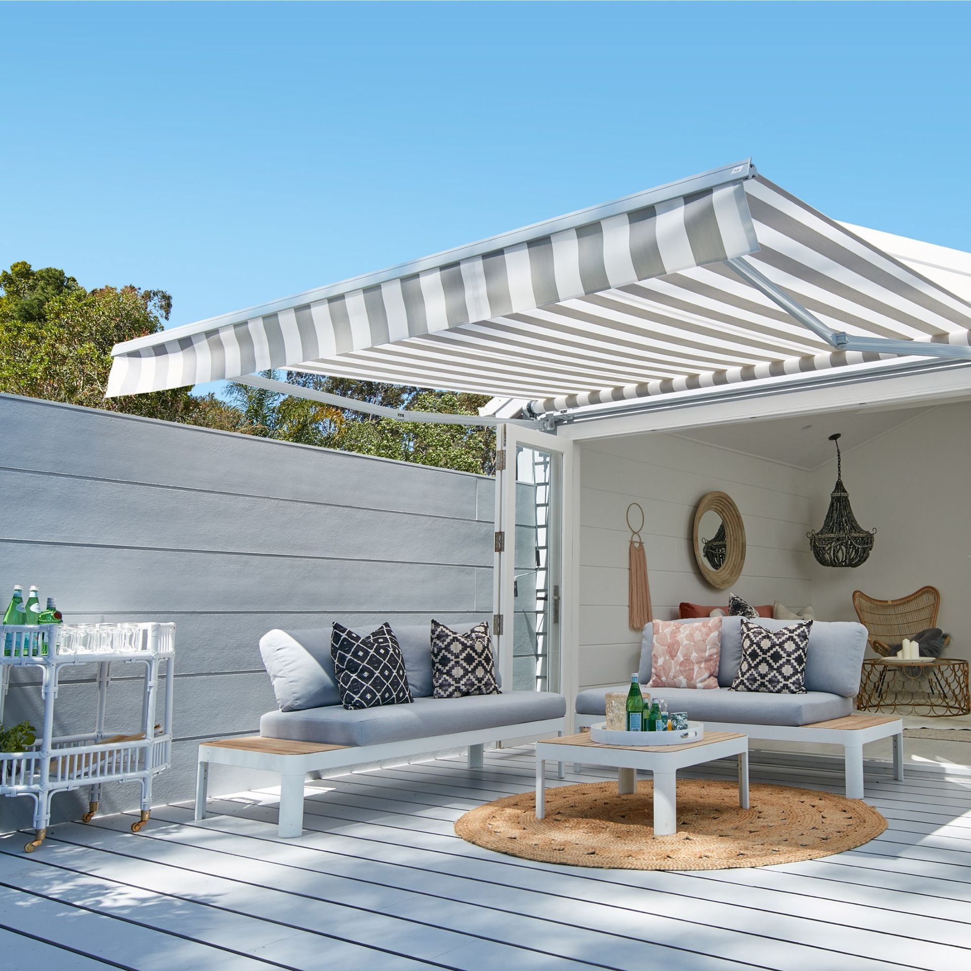 A patio with a striped awning over it