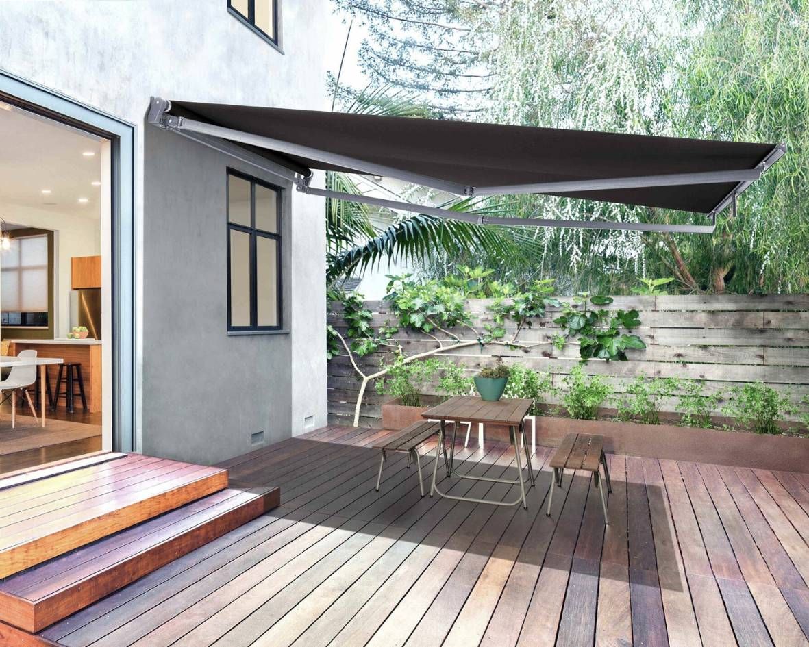 Outdoor patio deck with a retractable awning, furnished with a small table and chairs.