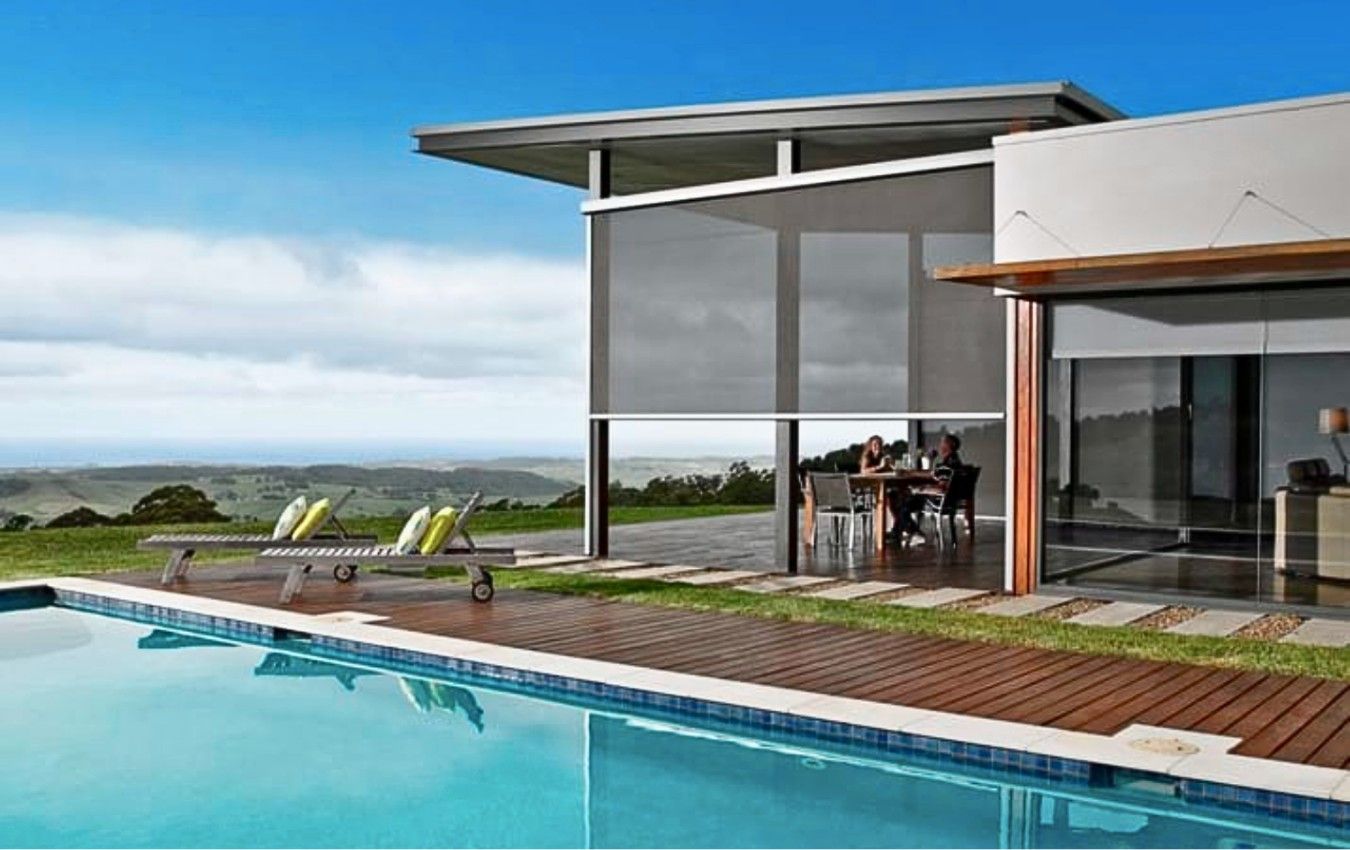 A house with a swimming pool in front of it.