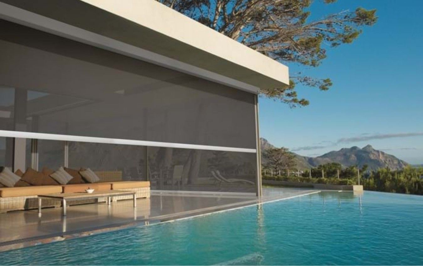 A house with a swimming pool in front of it.