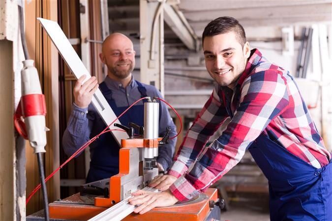 Two Men Are Working On A Machine In A Workshop — All Style Home Improvements in Hay Point, QLD