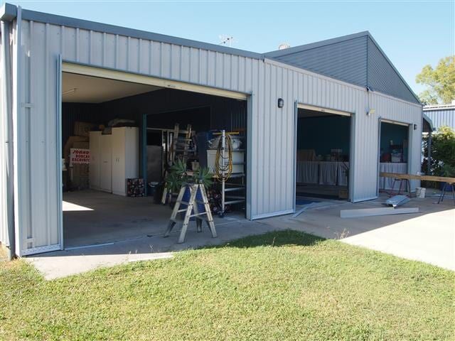 A Garage With The Doors Open And A Ladder In Front Of It — All Style Home Improvements in Hay Point, QLD