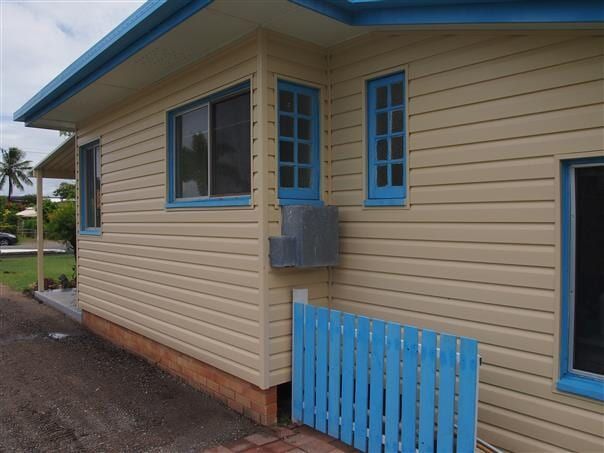 A House With Blue Windows And A Blue Fence — All Style Home Improvements in Hay Point, QLD
