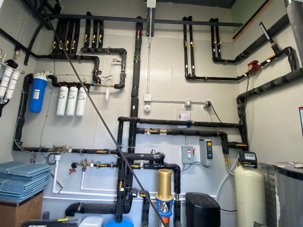 A room with a lot of pipes on the wall