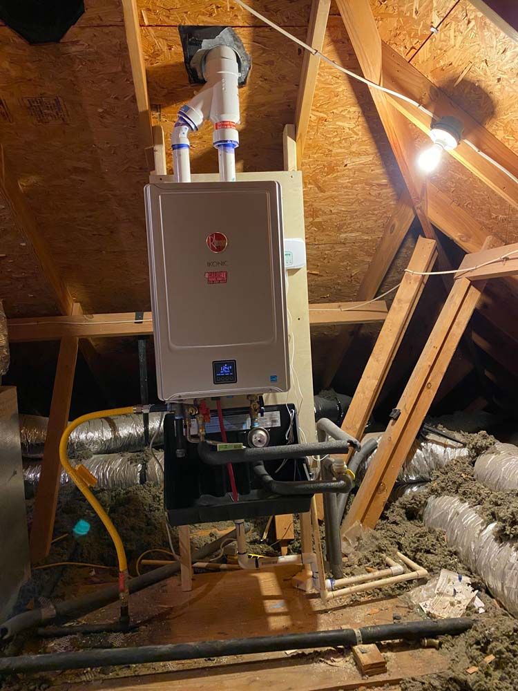 A boiler is sitting in the attic of a house.