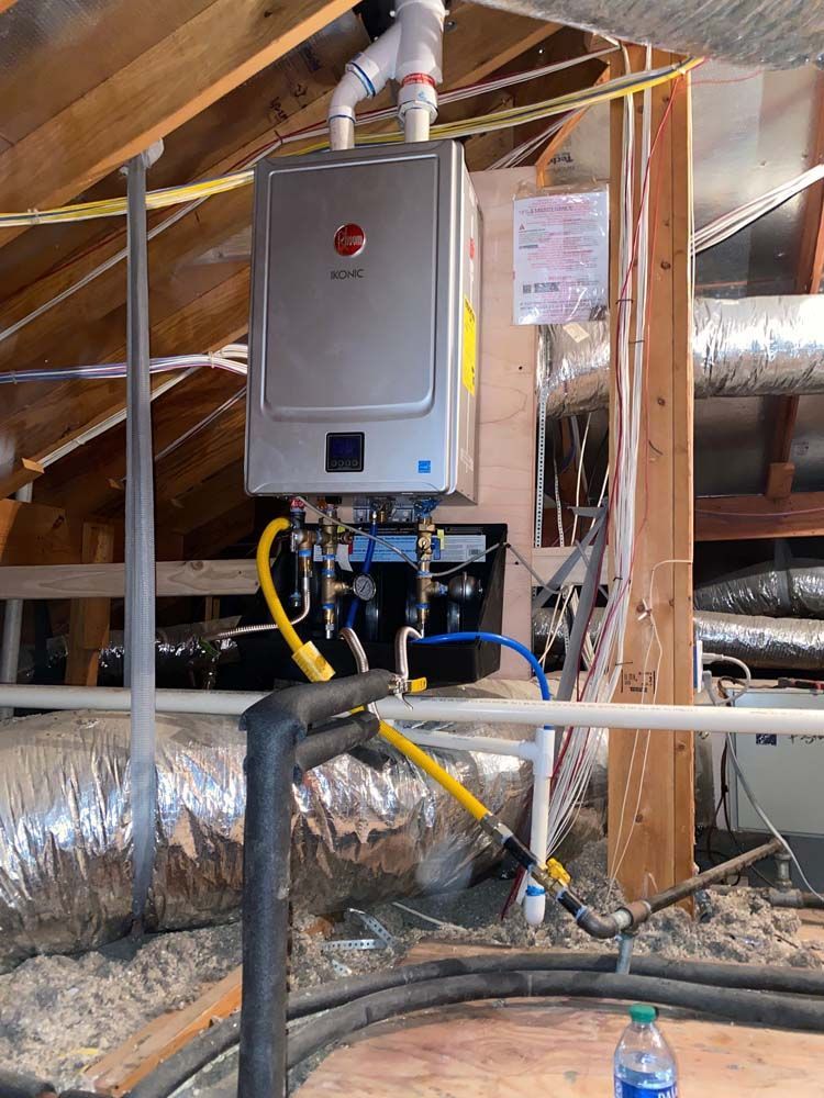 A water heater is installed in the attic of a house.