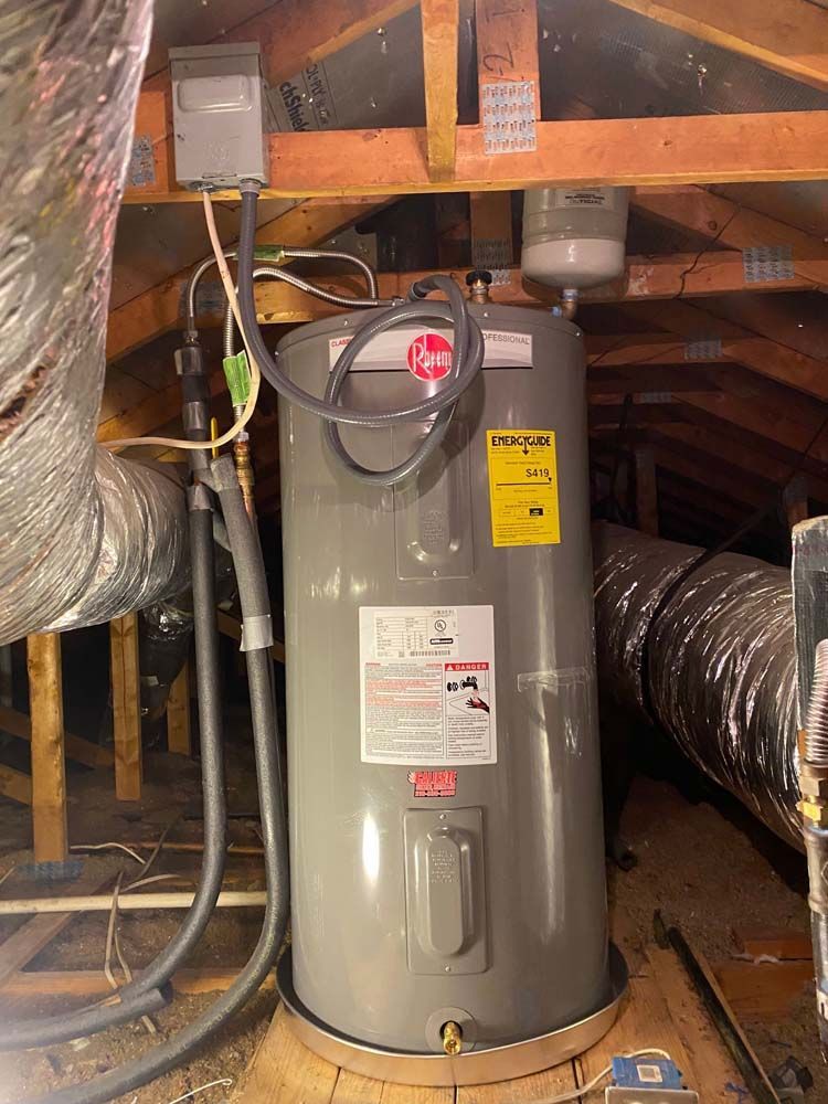 A water heater is sitting in the attic of a house.