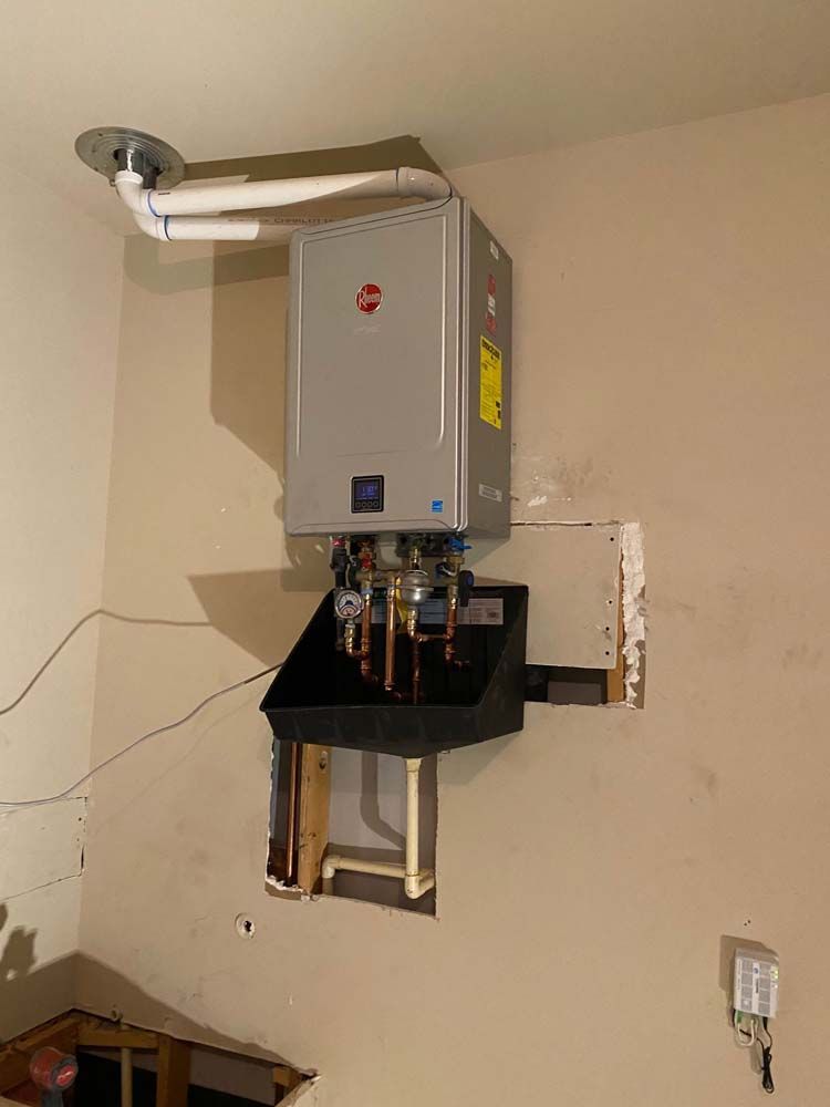 A water heater is hanging from the ceiling in a room.