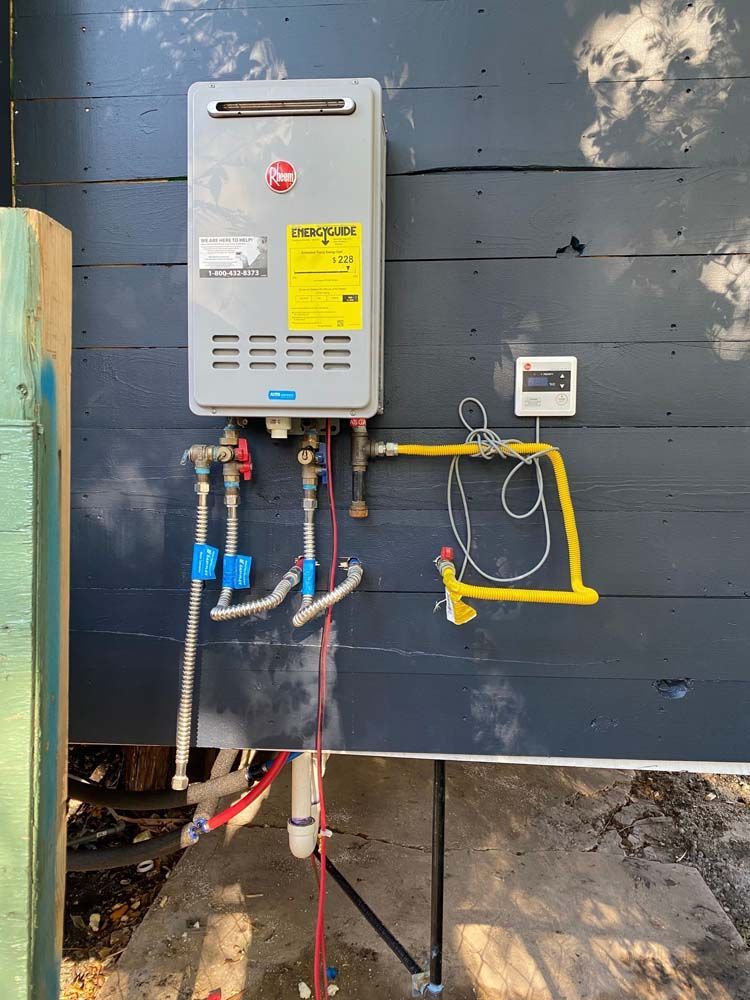 A water heater is installed on the side of a building.