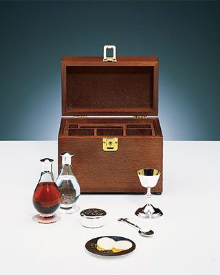 A wooden box filled with a variety of items on a table.