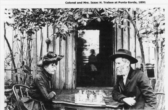 A wooden carving of a celtic knot in a triangle and circle.