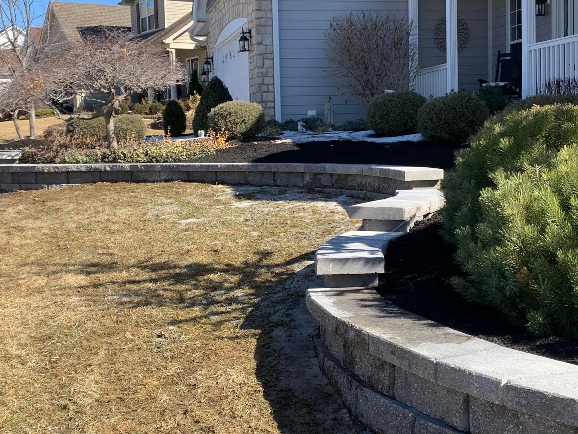 A Brick Wall in Front of A House with Steps Leading up To It | O’Fallon, MO | Vickscapes Land Maintenance and Pools