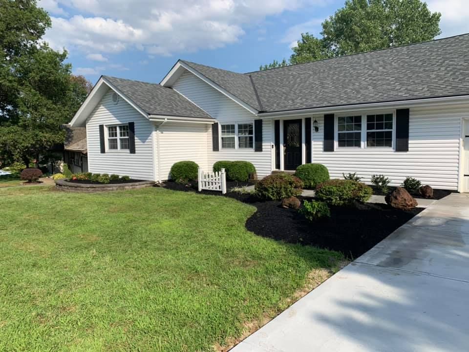 A White House with A Gray Roof and Black Shutters | O’Fallon, MO | Vickscapes Land Maintenance and Pools