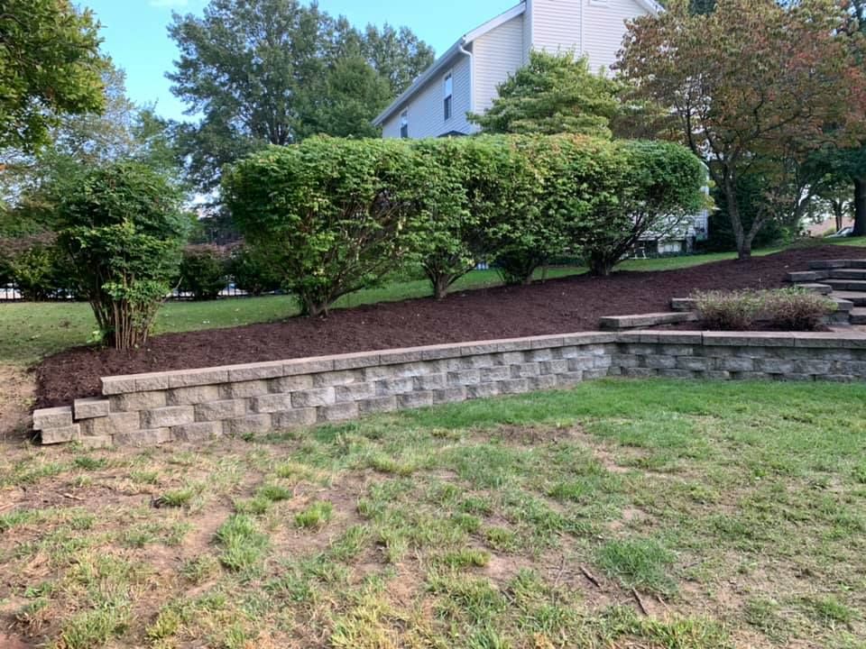 There Is a Brick Wall in The Middle of A Lush Green Field | O’Fallon, MO | Vickscapes Land Maintenance and Pools