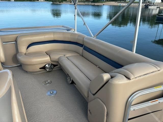 A gray recliner is sitting on a carpet in a living room.