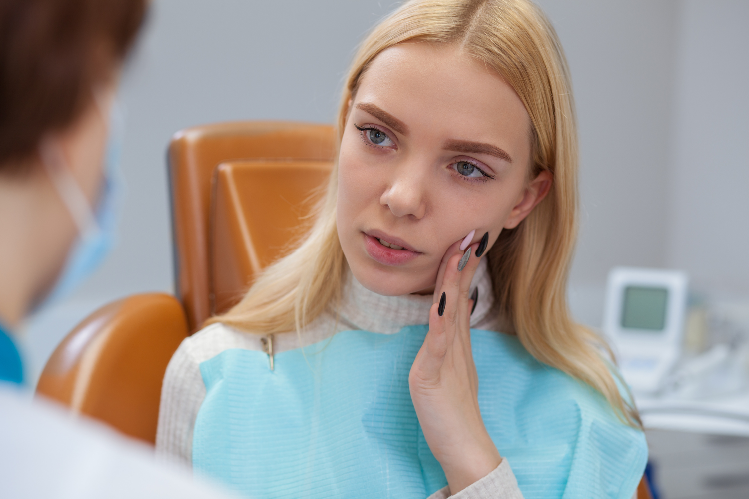 a woman in a dental chair has a toothache