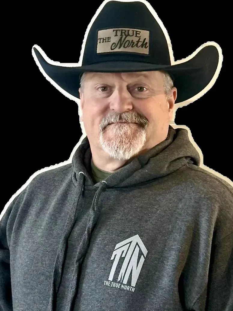 Man wearing a cowboy hat and gray hoodie with the logo 