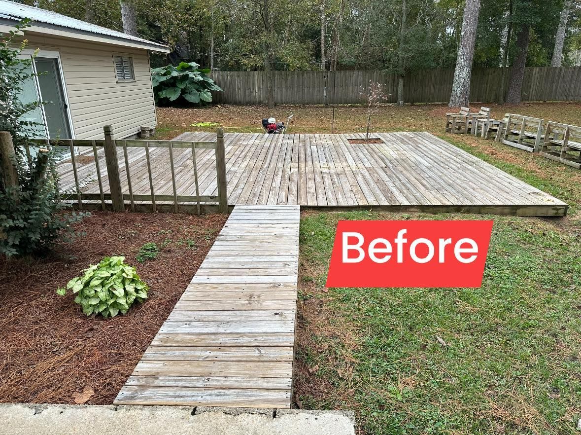 A before picture of a wooden deck in a backyard.