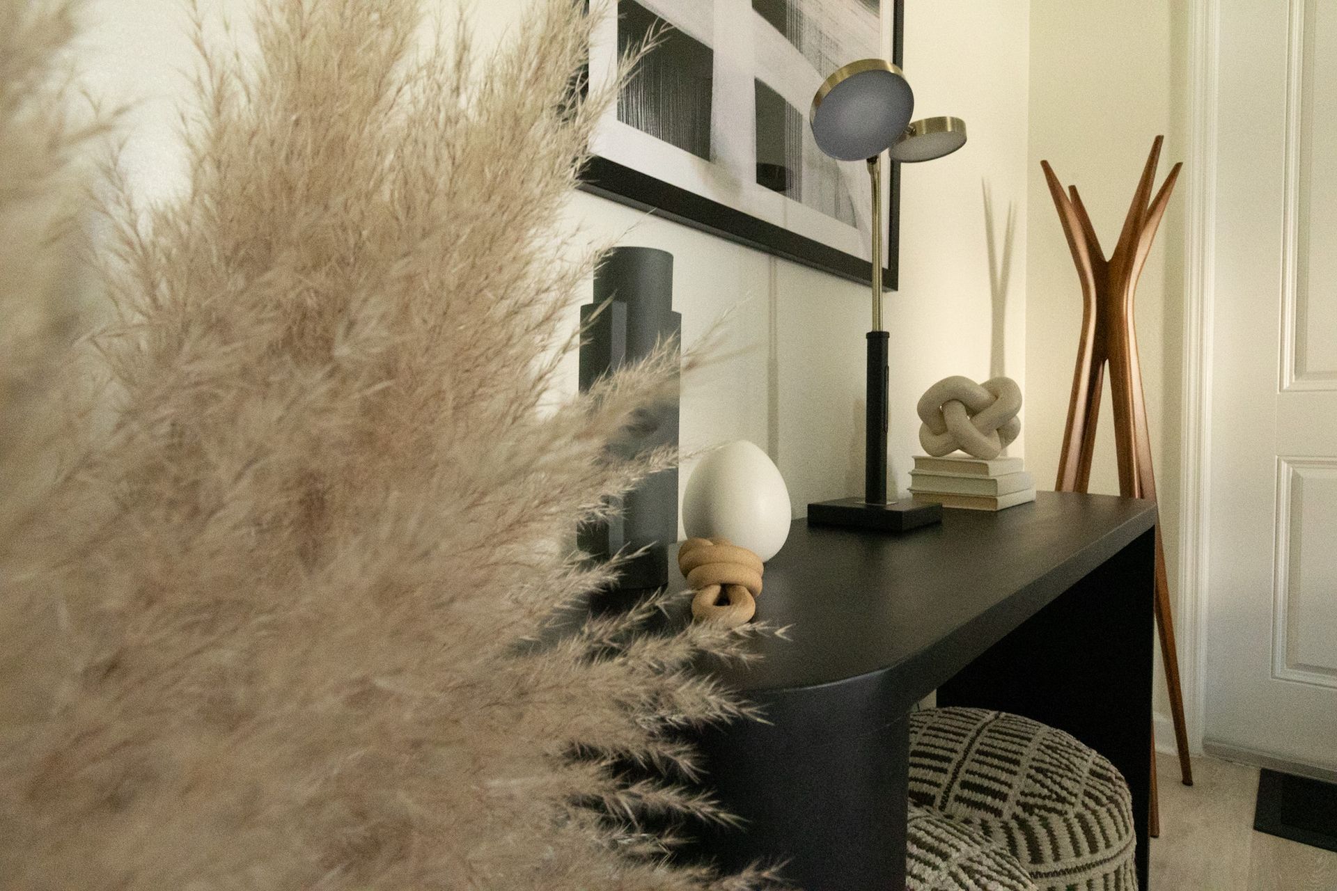 A dining room with a table and chairs and a black wall.