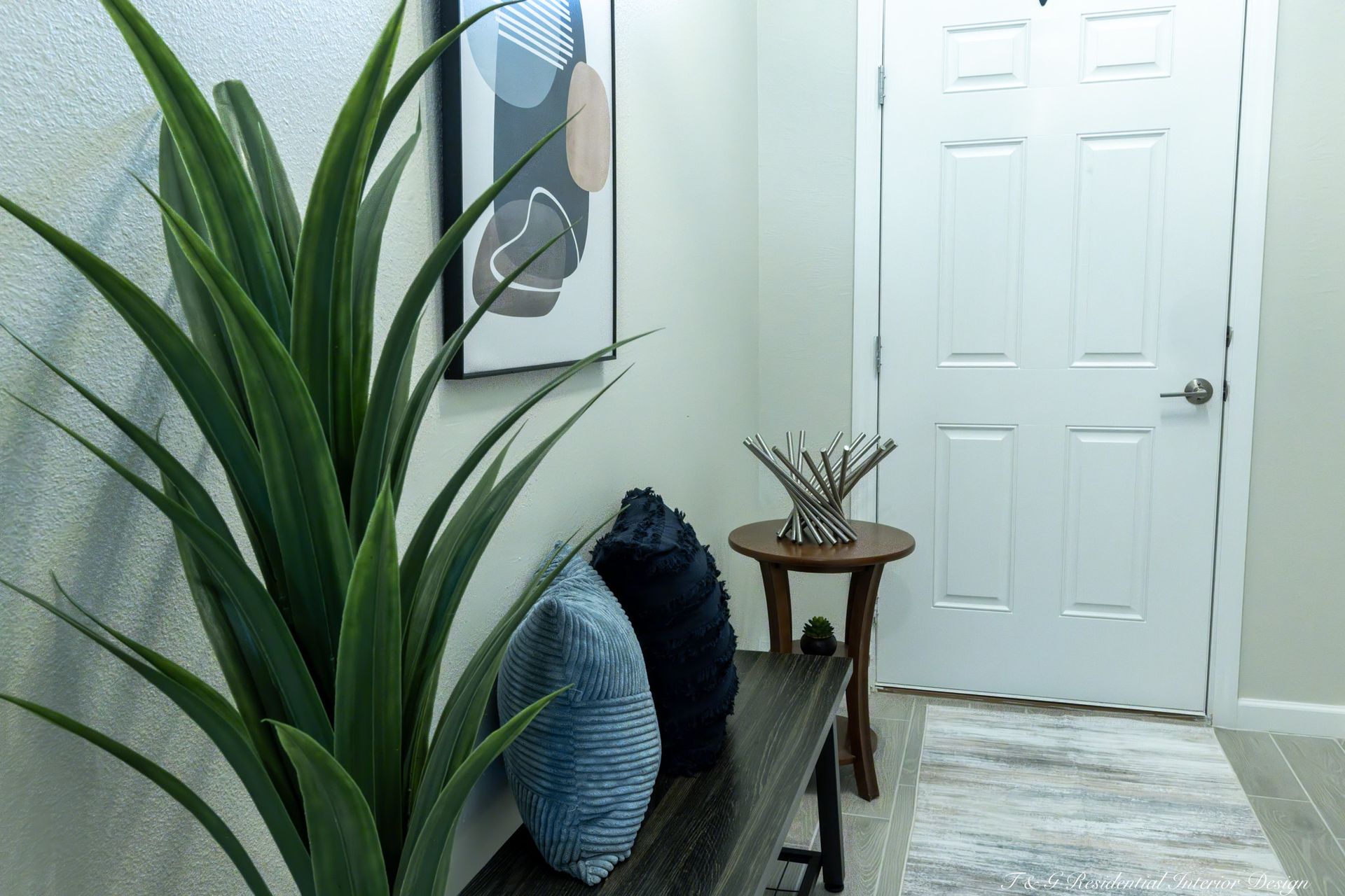 A bedroom with a bed, chair, and rug.