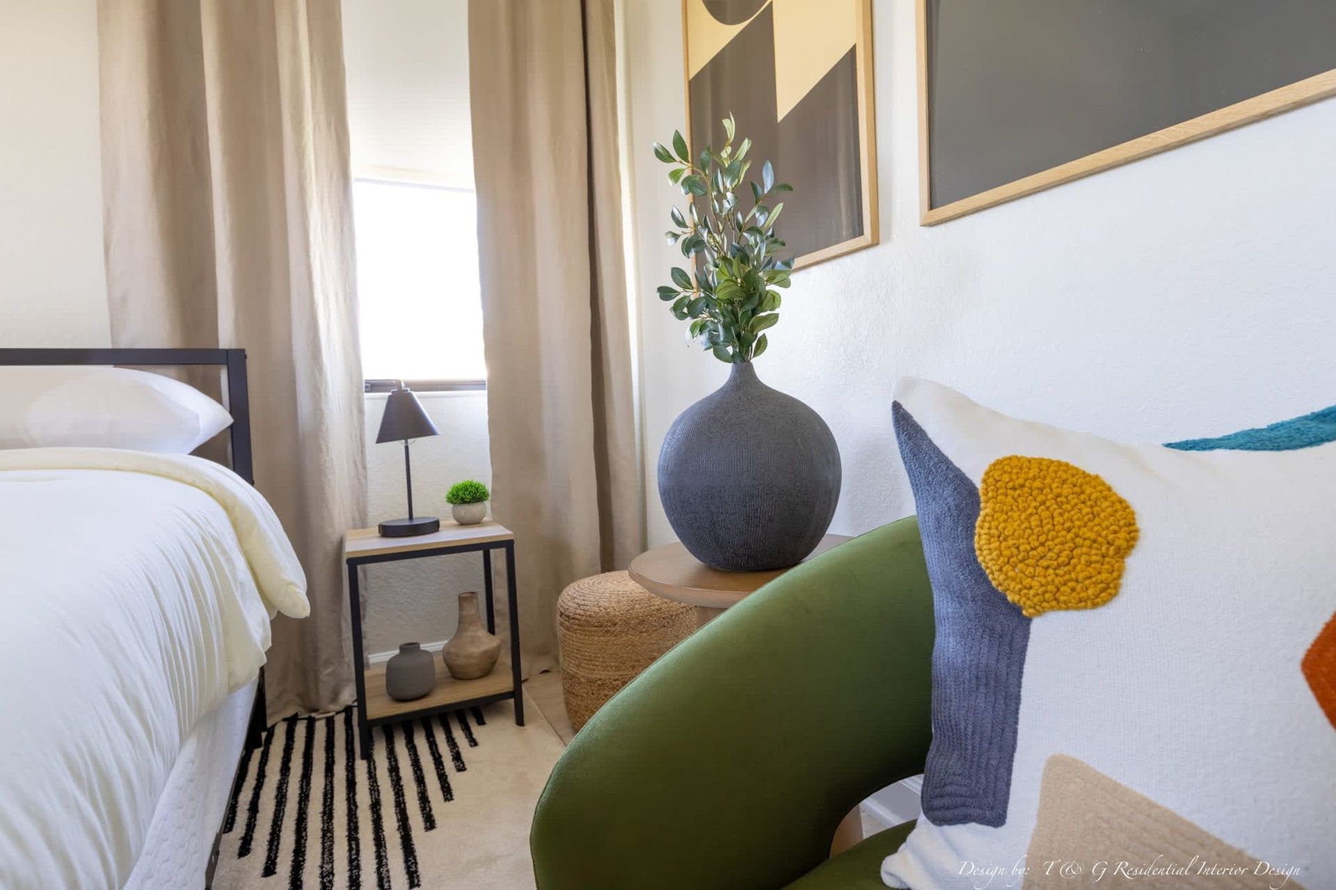 A bedroom with a bed, chair, and rug.