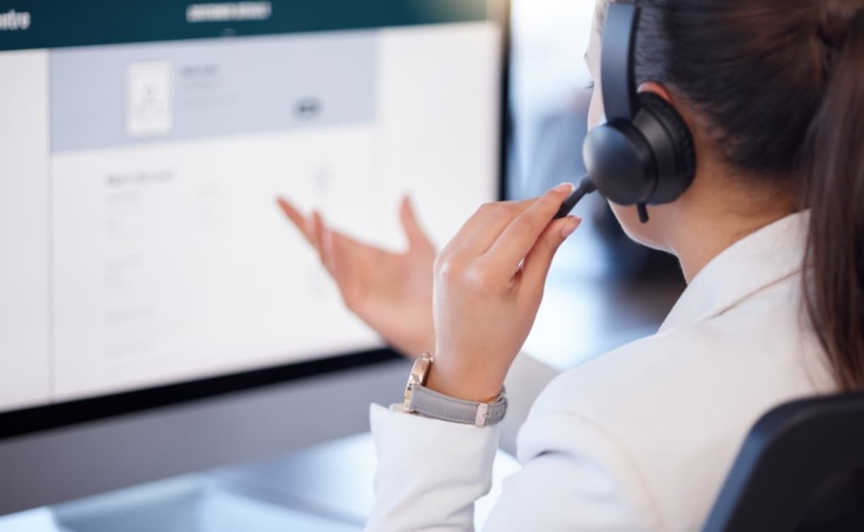 A Woman Wearing A Headset Is Sitting In Front Of A Computer — D-stress Computers In Idalia, QLD