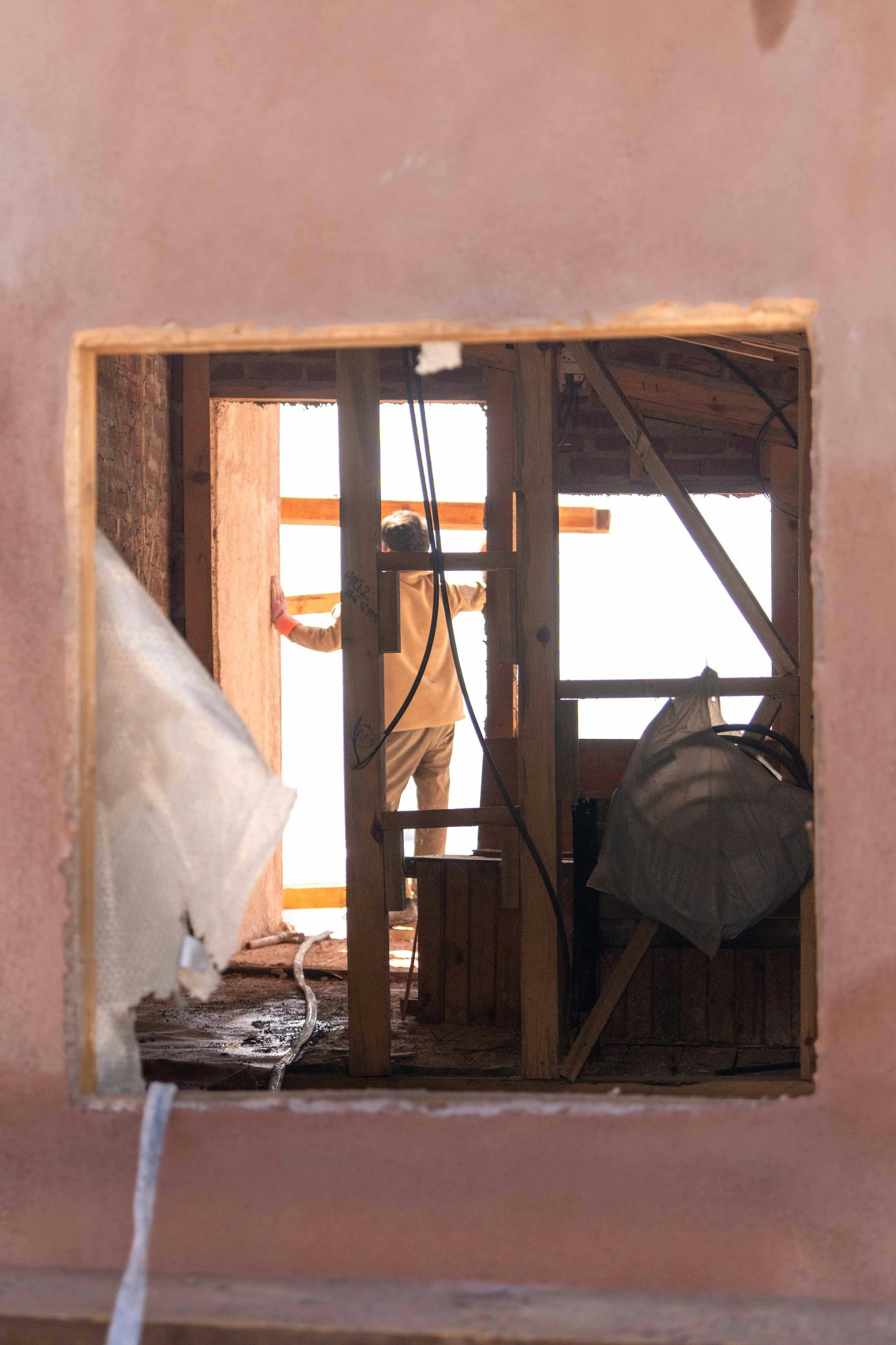 A hole in a wall with a window in it