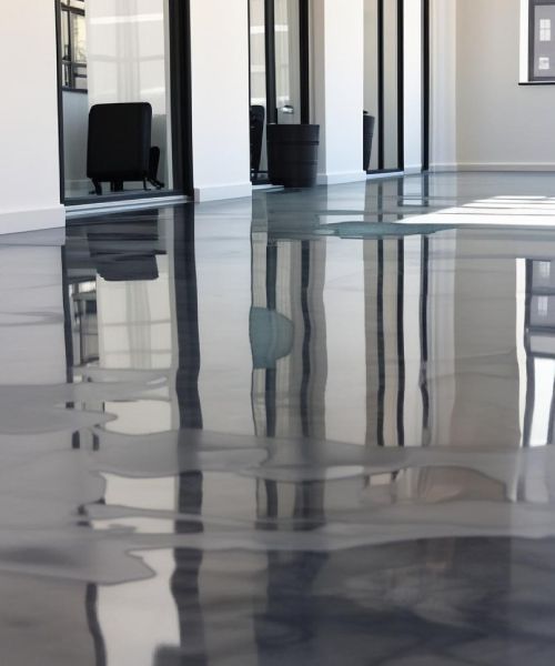 A room with a reflection of a building in the floor