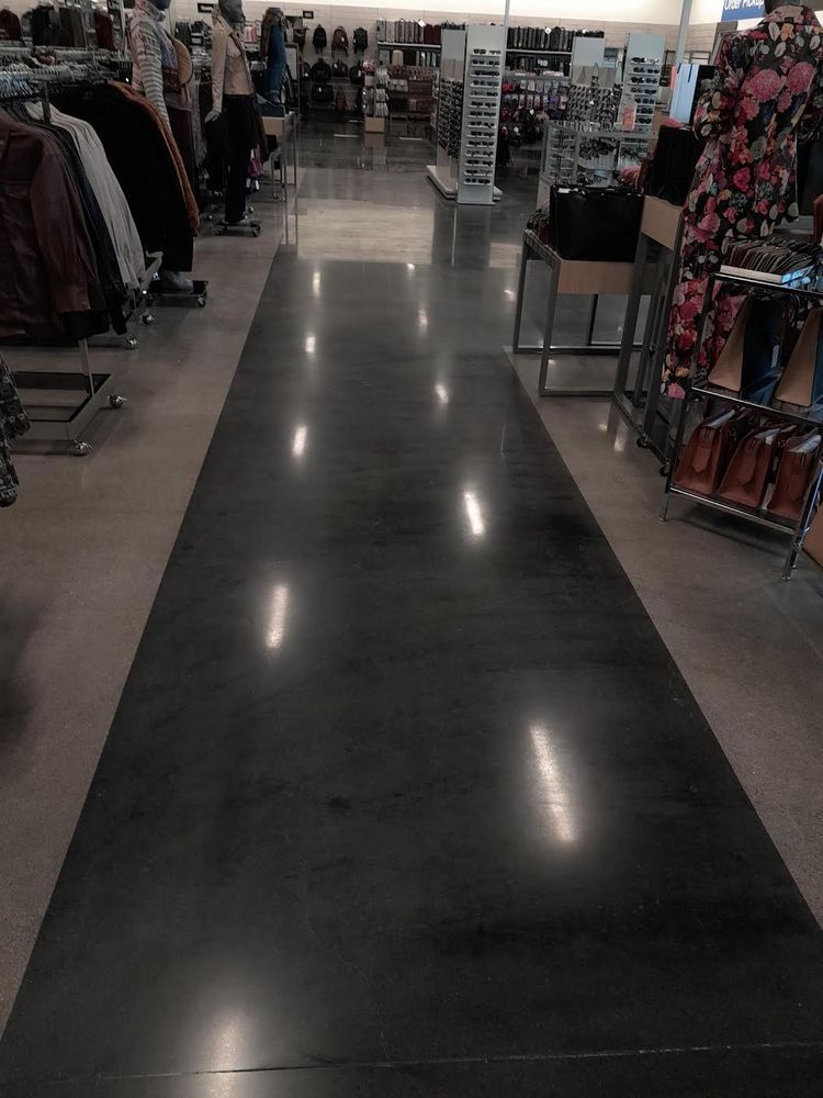 A store with a long black carpet going through it