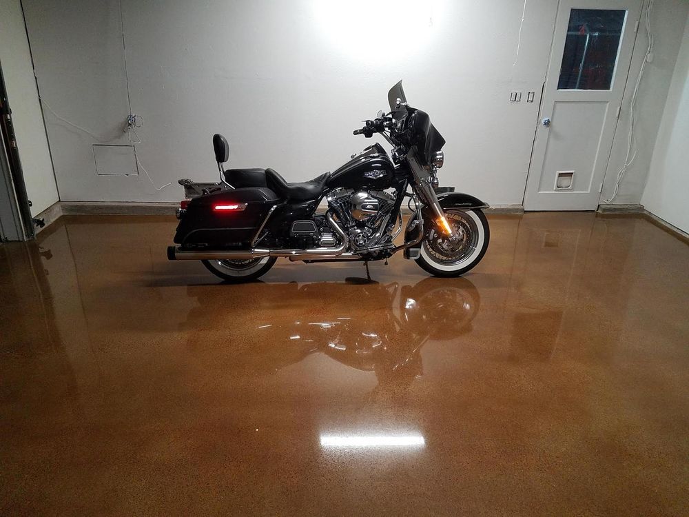 A black harley davidson motorcycle is parked in a garage.